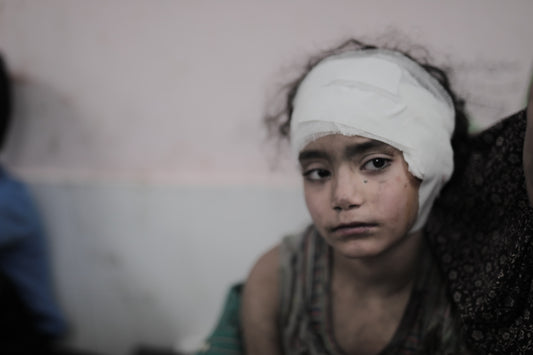 Girl Wrapped With Gauze from Head Shrapnel Injury