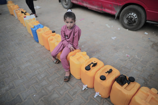 Child Sits on Empty Gallons of Water